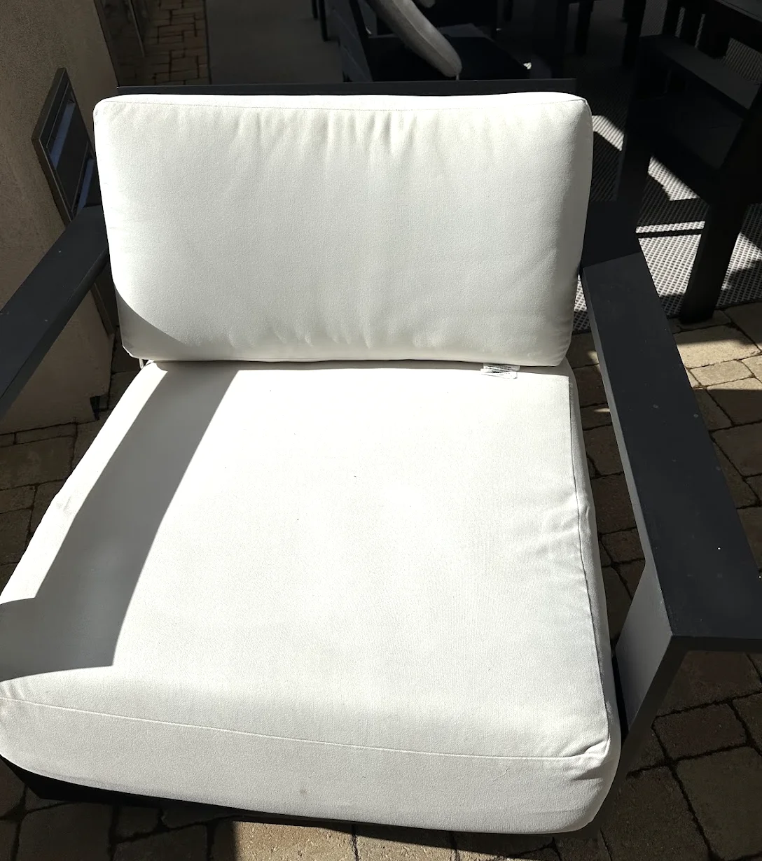 The same style of outdoor chair cushions clean and bright white after PatioMaid cushion cleaning