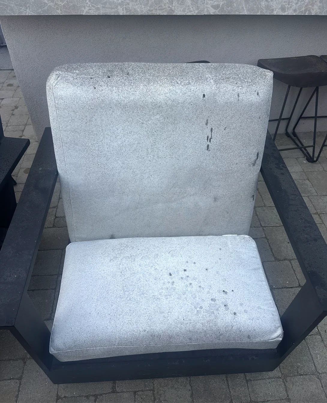 Outdoor lounge chair cushions with dark stains and spots before professional cleaning in San Diego