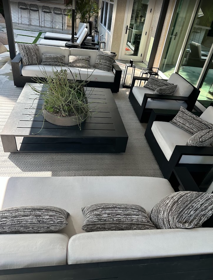 Clean wicker daybed with white cushions on a San Diego patio
