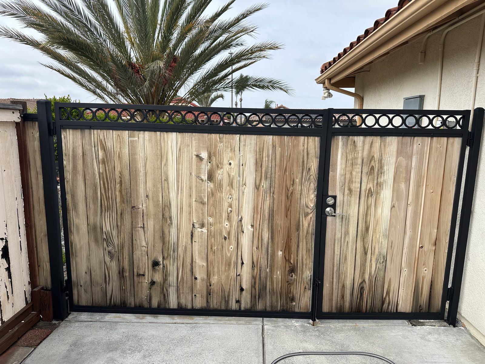 Weathered fence and gate restoration before PatioMaid cleaning in San Diego